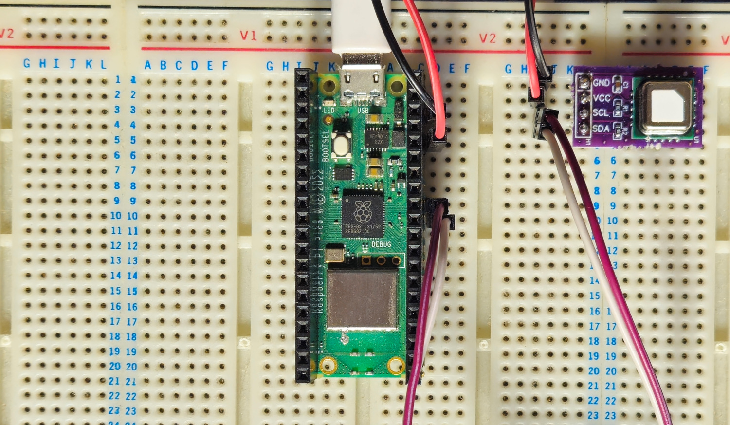 A Pico W next to a SCD40 module on a breadboard connected with some wires